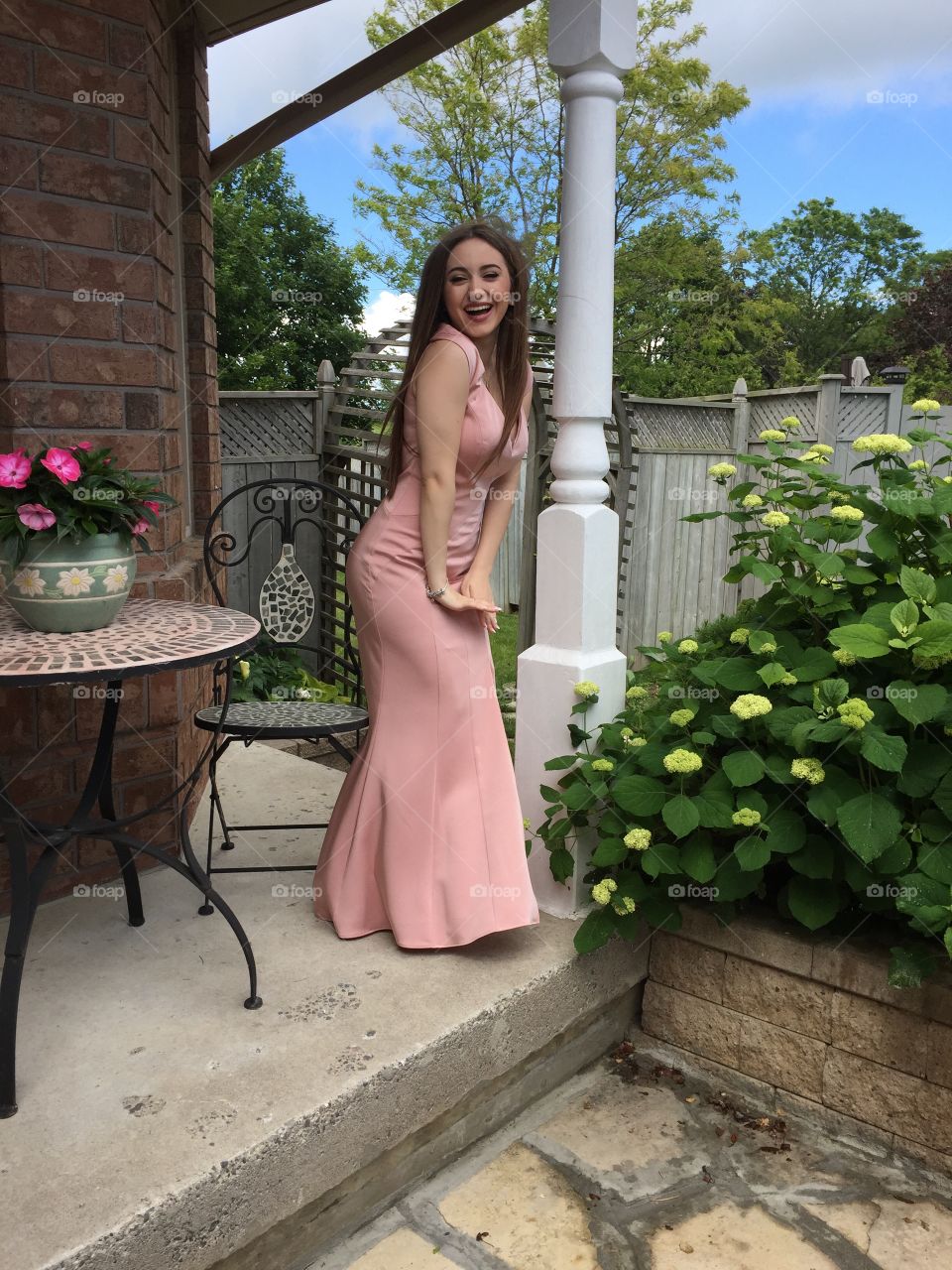 An excited girl on her prom day imitating the famous Marilyn Monroe.