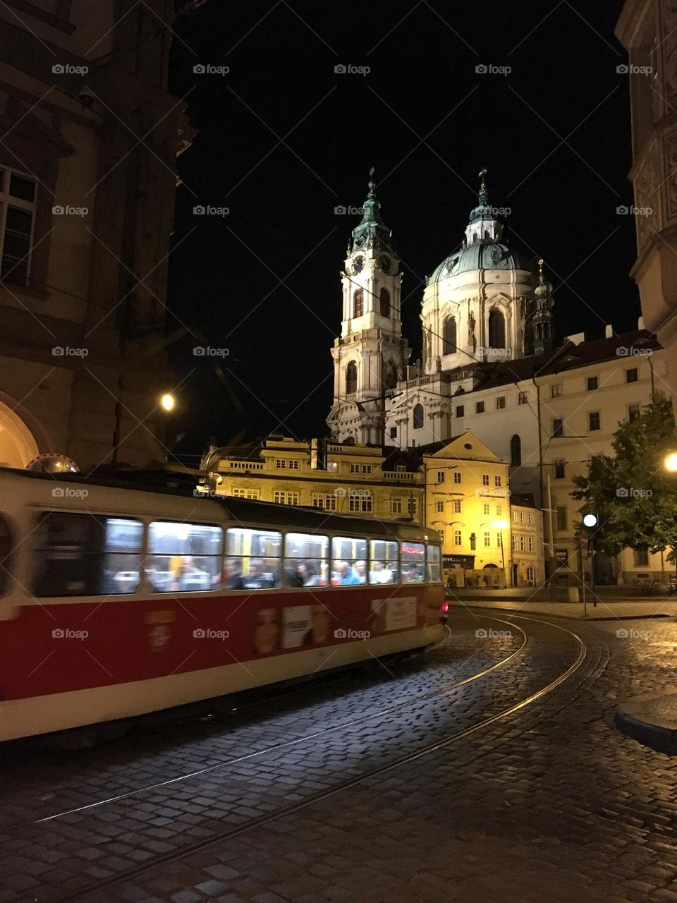 Tram wizzing through the town … glimpses of its passengers can be seen through the brightly lit windows … 