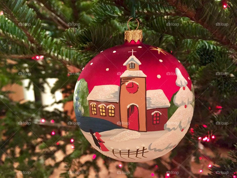 Glass globe with church and snow manually painted hanging in the Christmas tree 