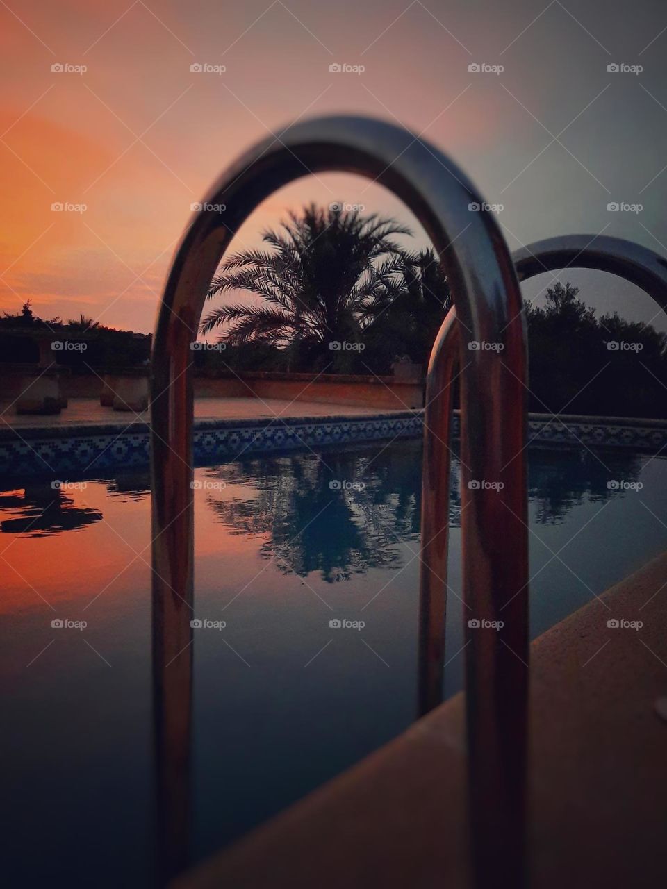 A dreamy sunset over a pool with views of the countryside. The magical light of these moments was creating a wonderful visual spectacle with the reflections of the water.