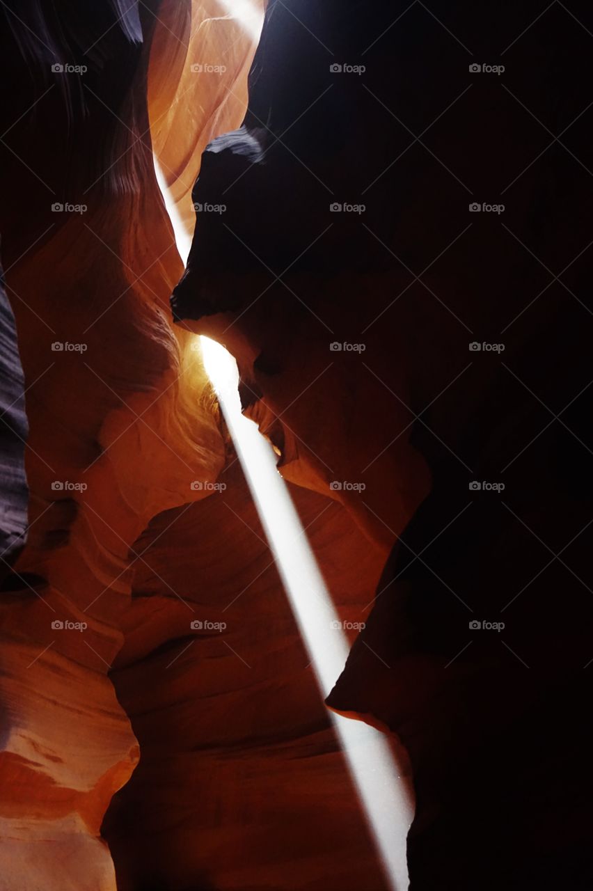 a ray of light like as a sword in the stones of a canyon