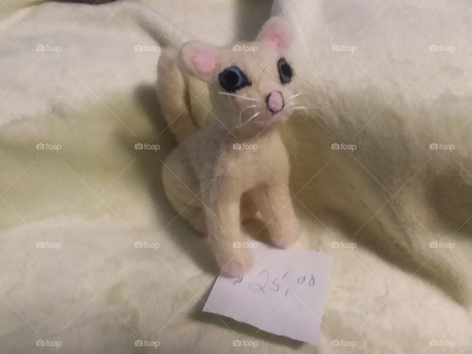 A needle felted white cat made for a crafts sale at my church.