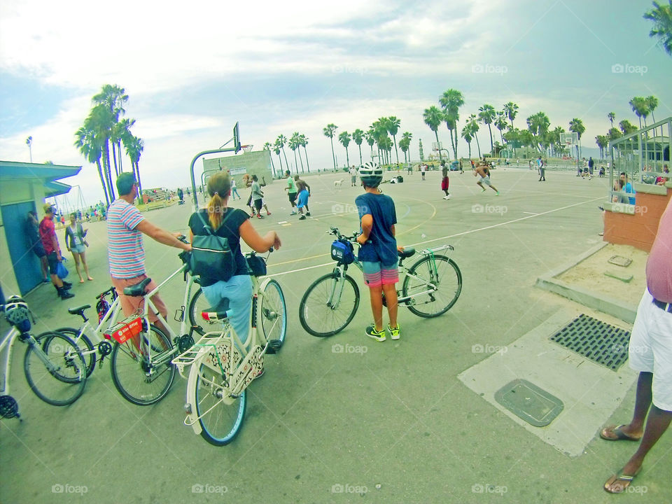 Venice beach basketball court activity and bikers