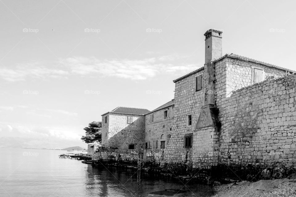 An old house with walls in the sea