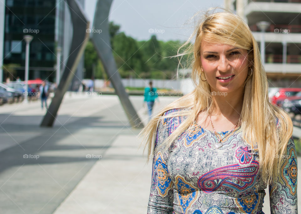 Portrait of blonde woman standing on street