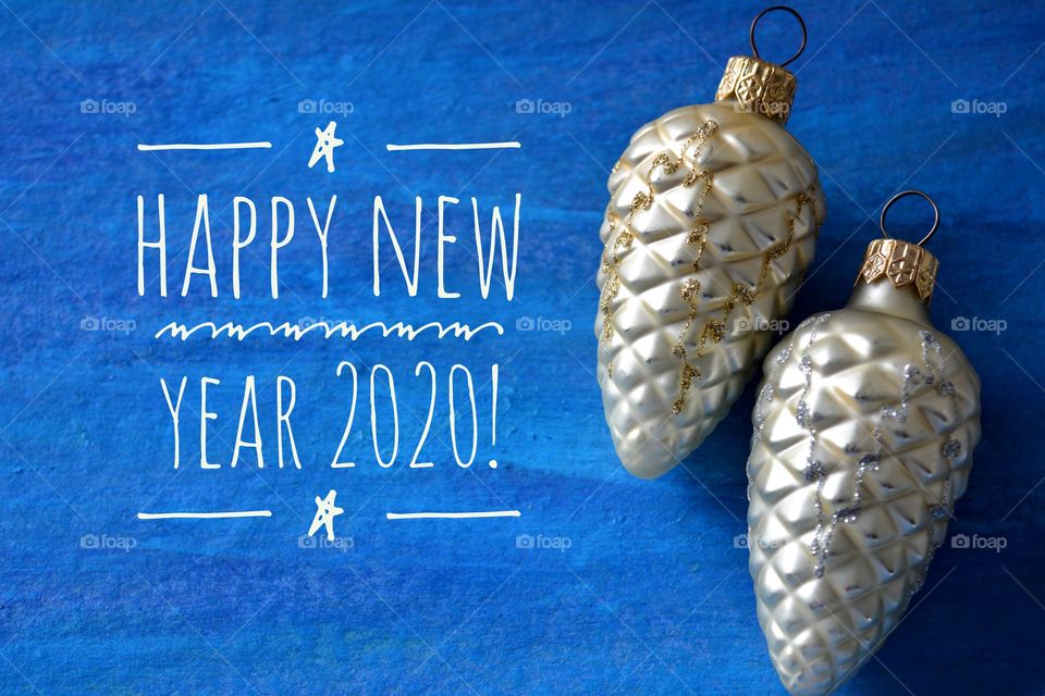 Merry Christmas and Happy New Year 2020 text and decorations blue background