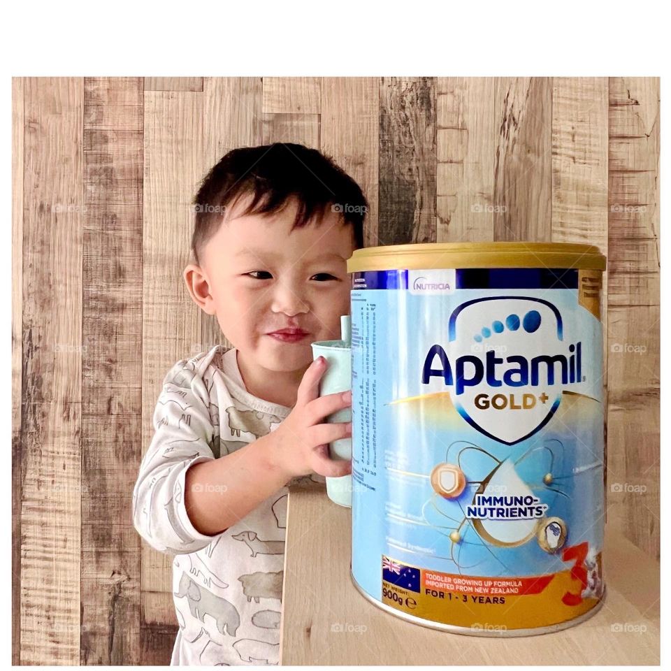 Happy boy with his favourite growing up milk formula 