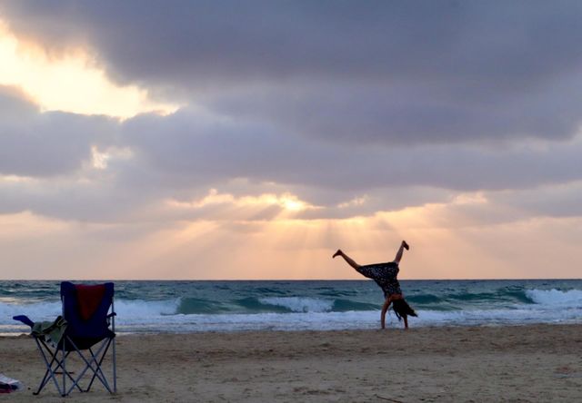 Girl flipping on the beach
