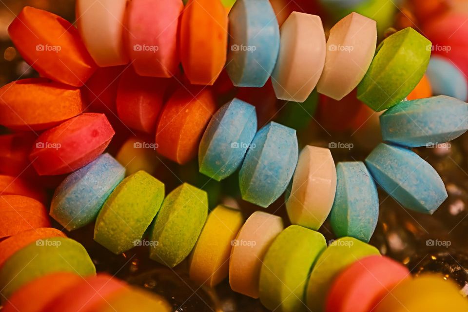 Up close and personal macro of a favorite of childhood, the colorful and delicious candy necklace , sweet and tart