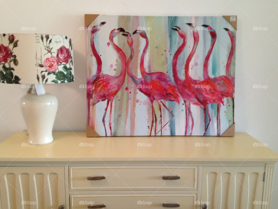 Pink flamingos and lamp on a table