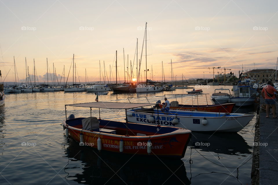 sunset between boats. a day in syracuse