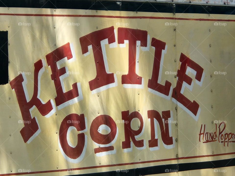 red and yellow kettle corn food truck at outdoor market