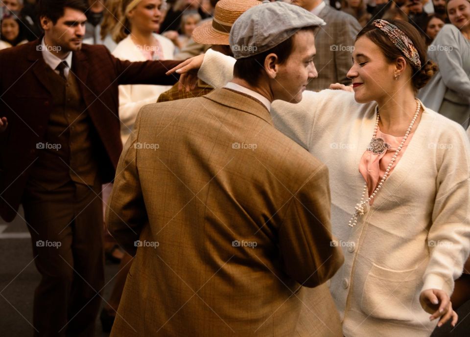 couple dressed in retro style dancing on the street