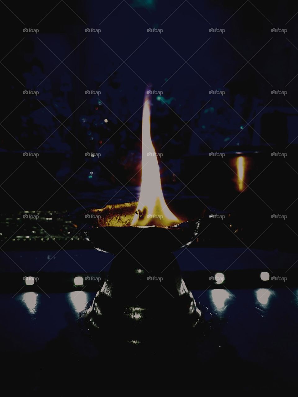 Light lamp (Diya) infront of hindu god