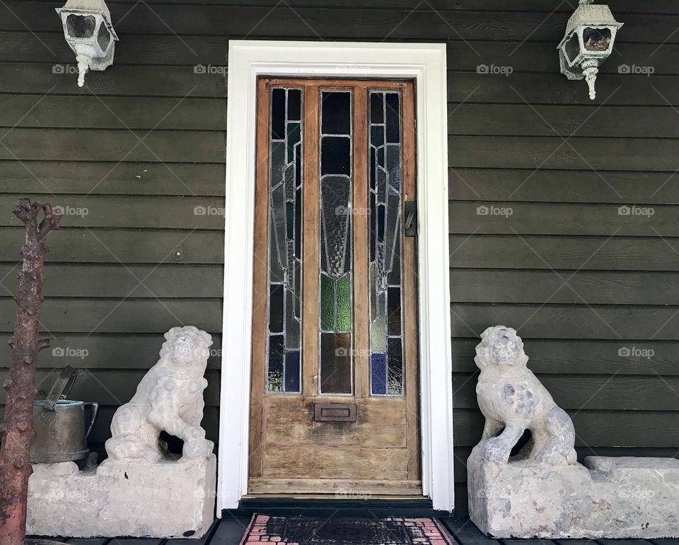 Play wooden front door with lion statues on both sides