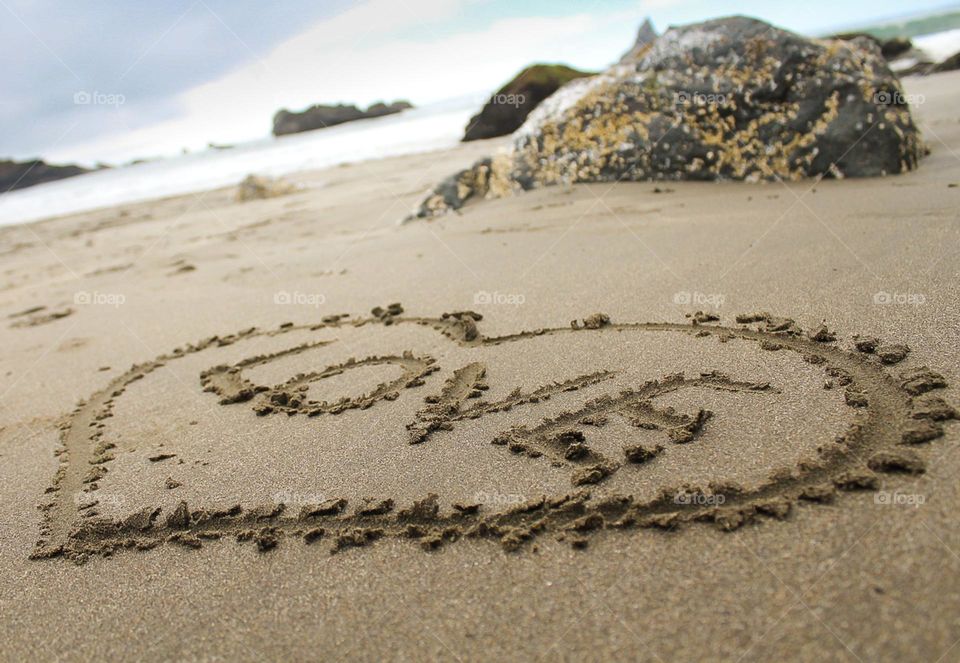 The word “LOVE” written on sand at the beach 