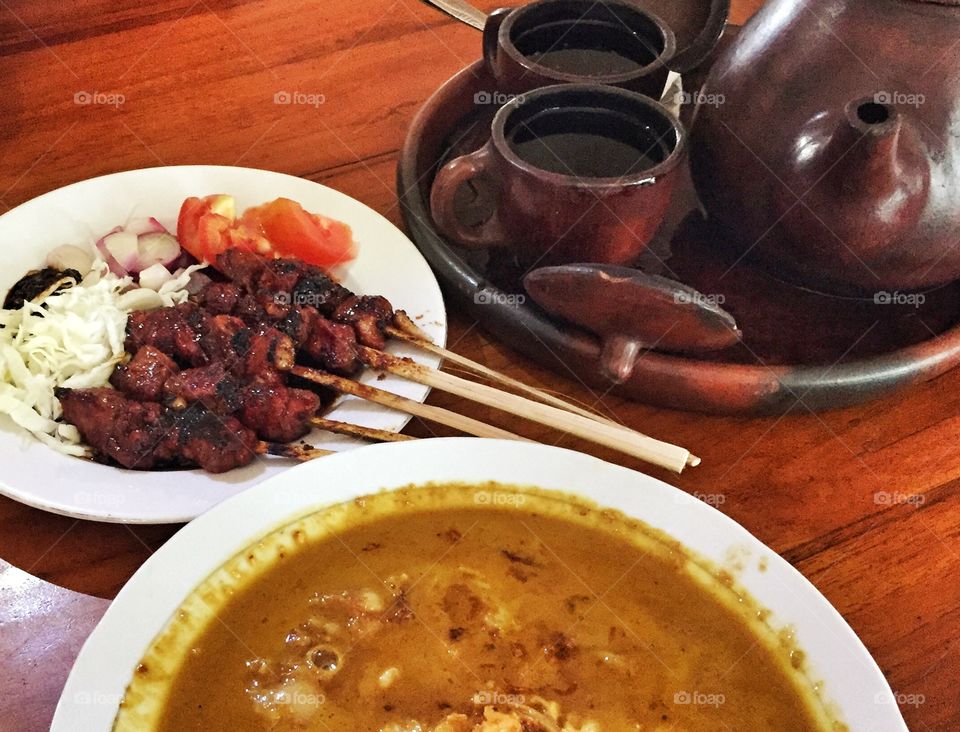traditional goat meat skewer served with soap & traditional indonesian tea