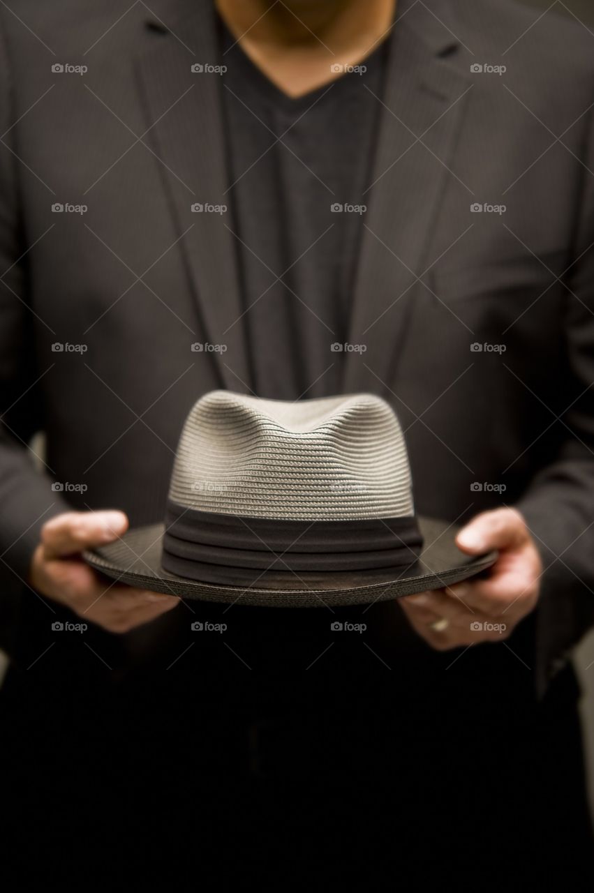 Man holding a Fedora