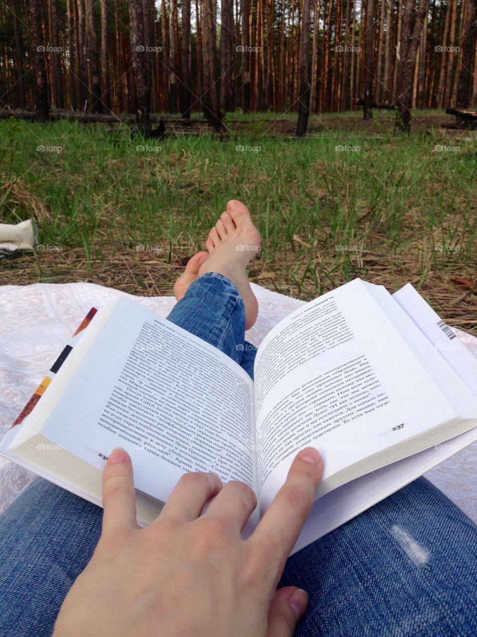 Reading a book in the forest glade