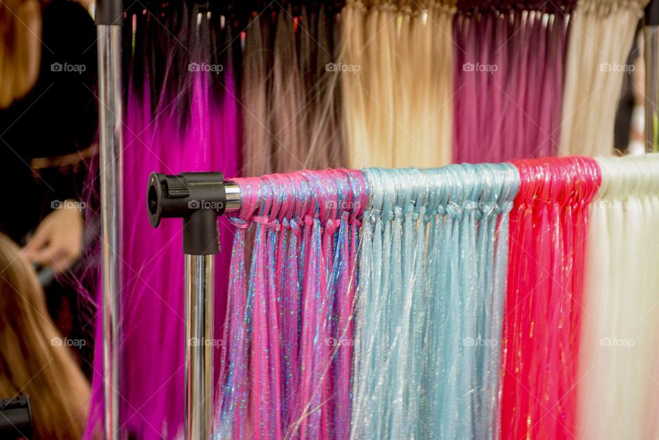 Multi-colored beautiful artificial hair in a beauty salon