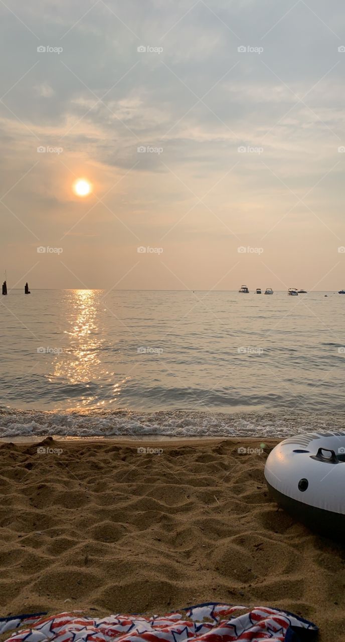 The sun setting and reflecting on the water. 