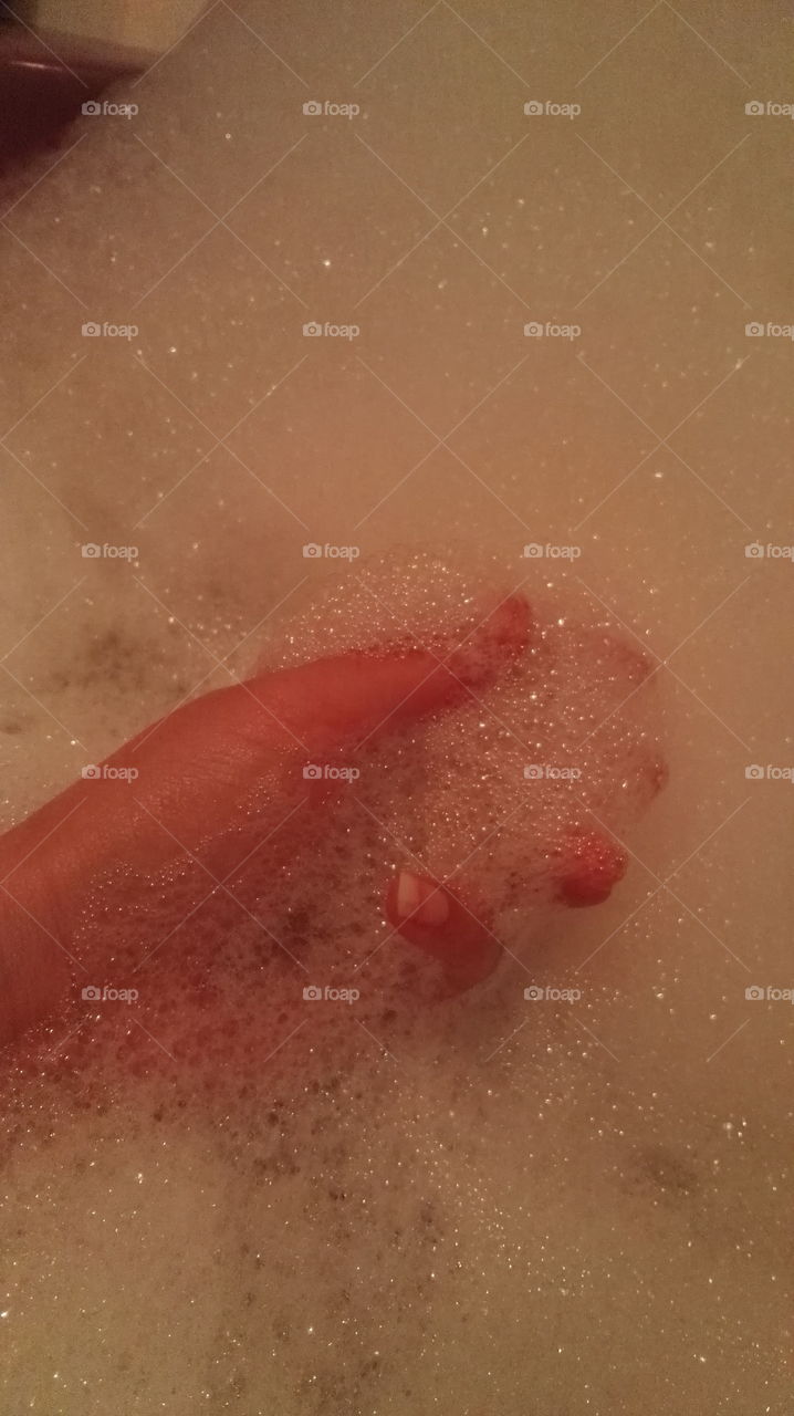 woman hand in bath foam
