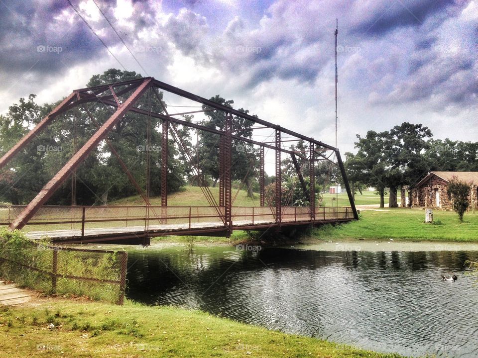 Truss bridge over creek. 