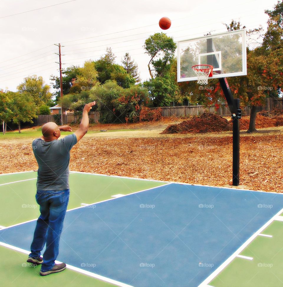 standing at the free throw line shooting a free-throw shot