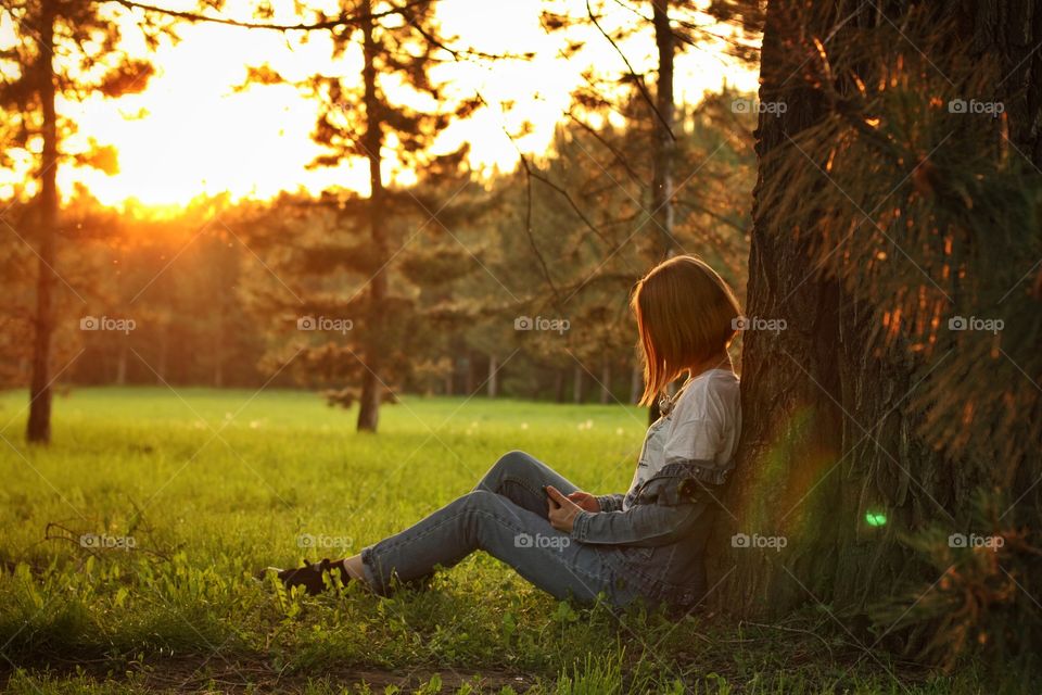girl in park with her phone