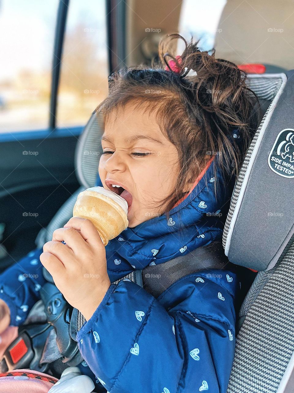 Toddler girl eating ice cream with mouth wide open, funny portrait of toddler girl, smartphone photography, toddler girl eats ice cream cone with force, toddler girl loves ice cream, eating ice cream in the car, toddler eating ice cream cone
