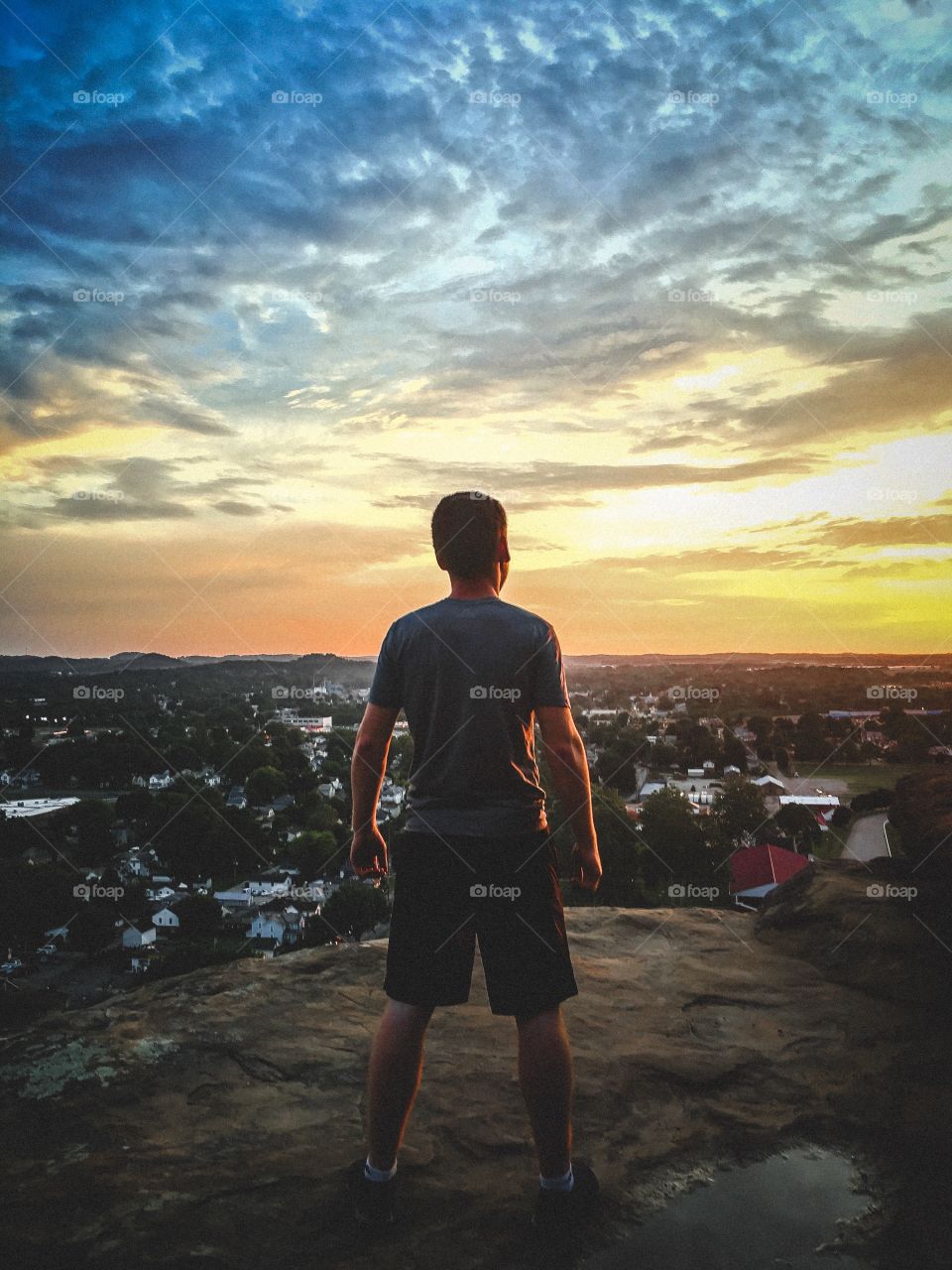 Awesome sunset with an awesome model on a mountain looking over the city!
