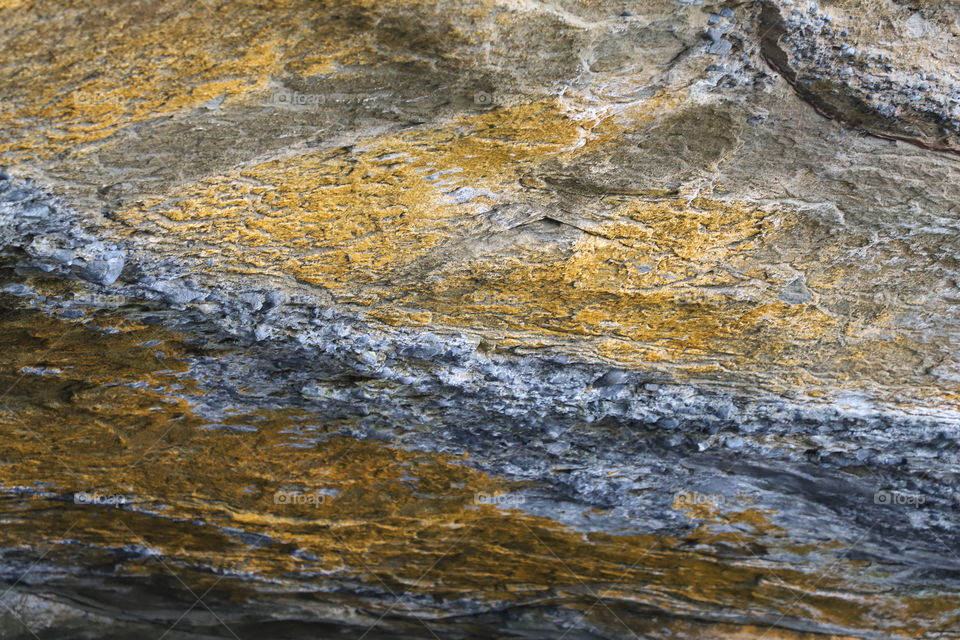 Big rock with yellow surface unique texture 