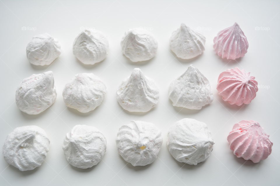 sugar meringues on a white background top view beautiful texture