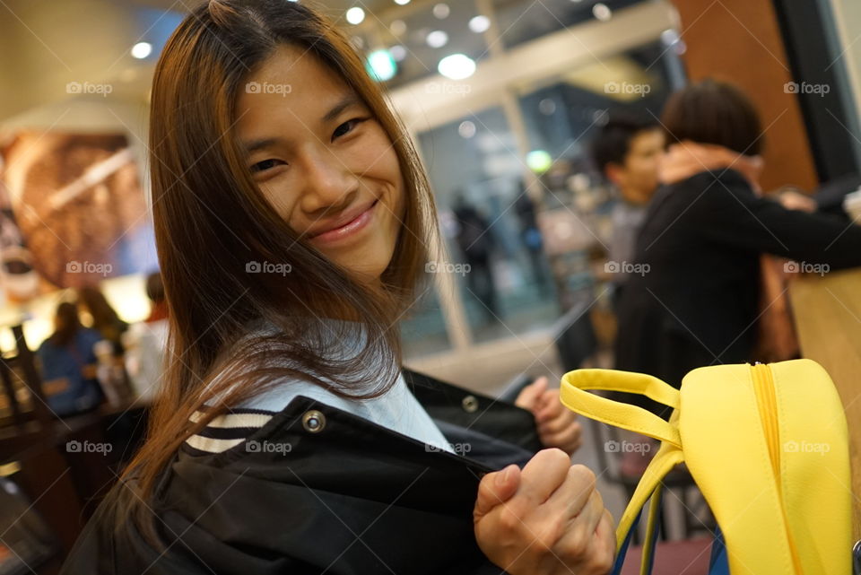 Happy Japanese girl in cafe