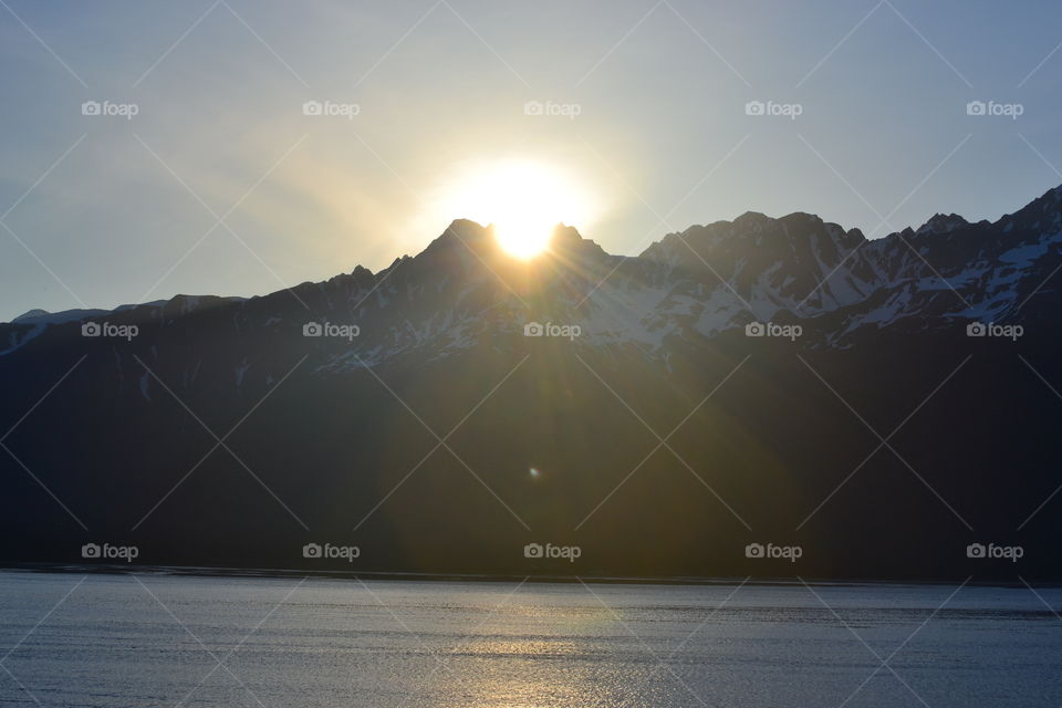 Sunrise Over Seward Mountains. The sun clearing a gap in the mountains in Seward, AK