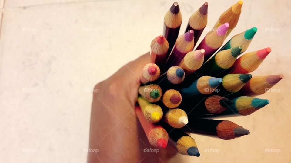 Colored pencils in hand