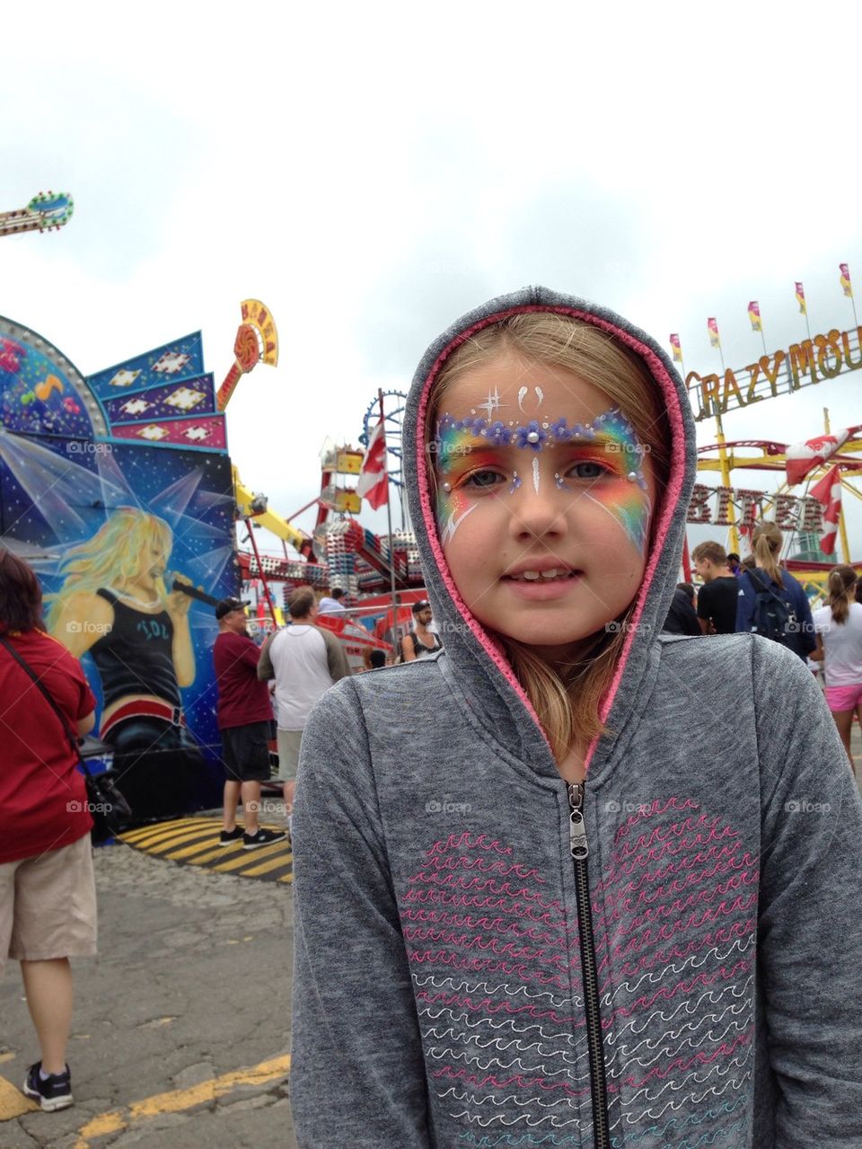 Portrait of girl with face paint standing in amusement park