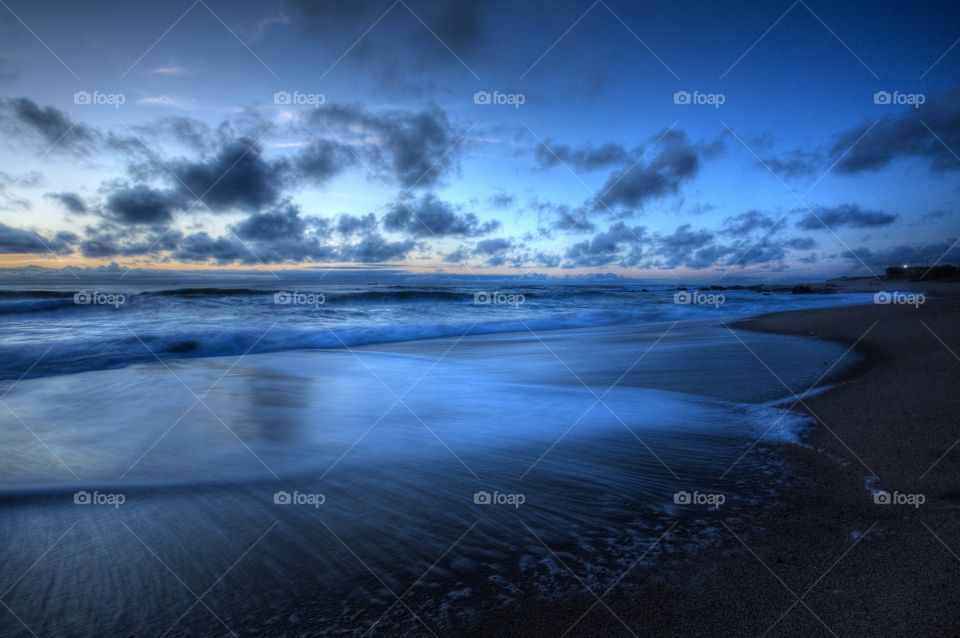 Cloudy sky reflecting in sea