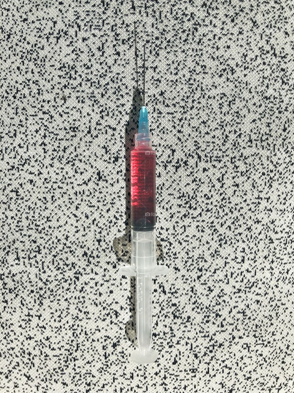 Syringe filled with pink medicine ready to inject
