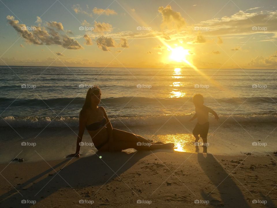 Mom, son and the most beautiful sunset on the ocean