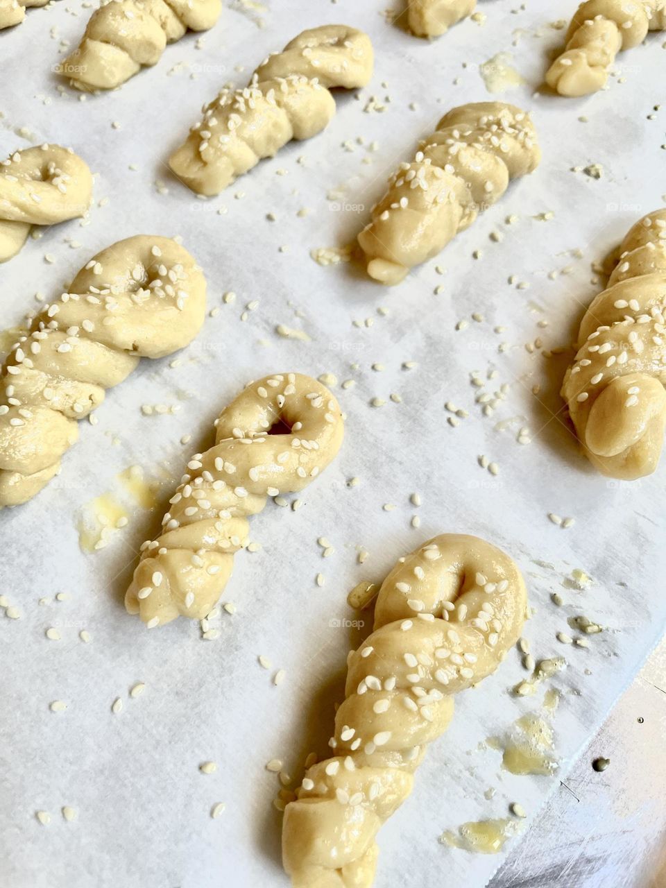 Baking cookies, Greek koulourakia for holy week, top view, cookies on baking sheet parchment