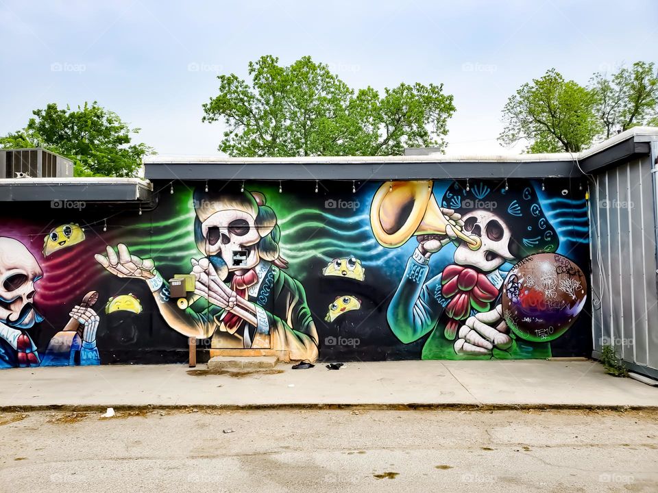 Street art celebrating Dia De Los Muertos/ Day of the Dead.  A Mexican cultural tradition of remembering and celebrating those that have passed.  The art depicts dead Mexican culture musicians.