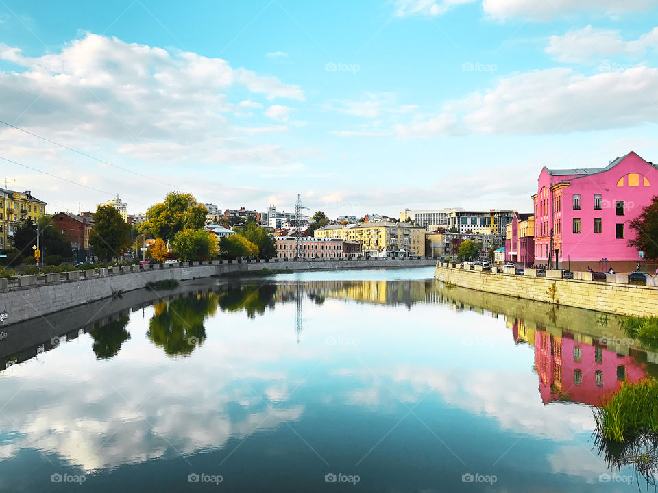 Symmetrical cityscape of old architecture over the river in old Europe 