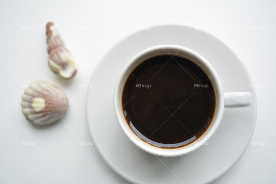 coffee cup with candy top view on a white background