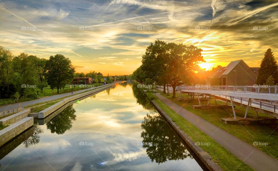 Colorful and dramatic sunset over the canal reflected in the water