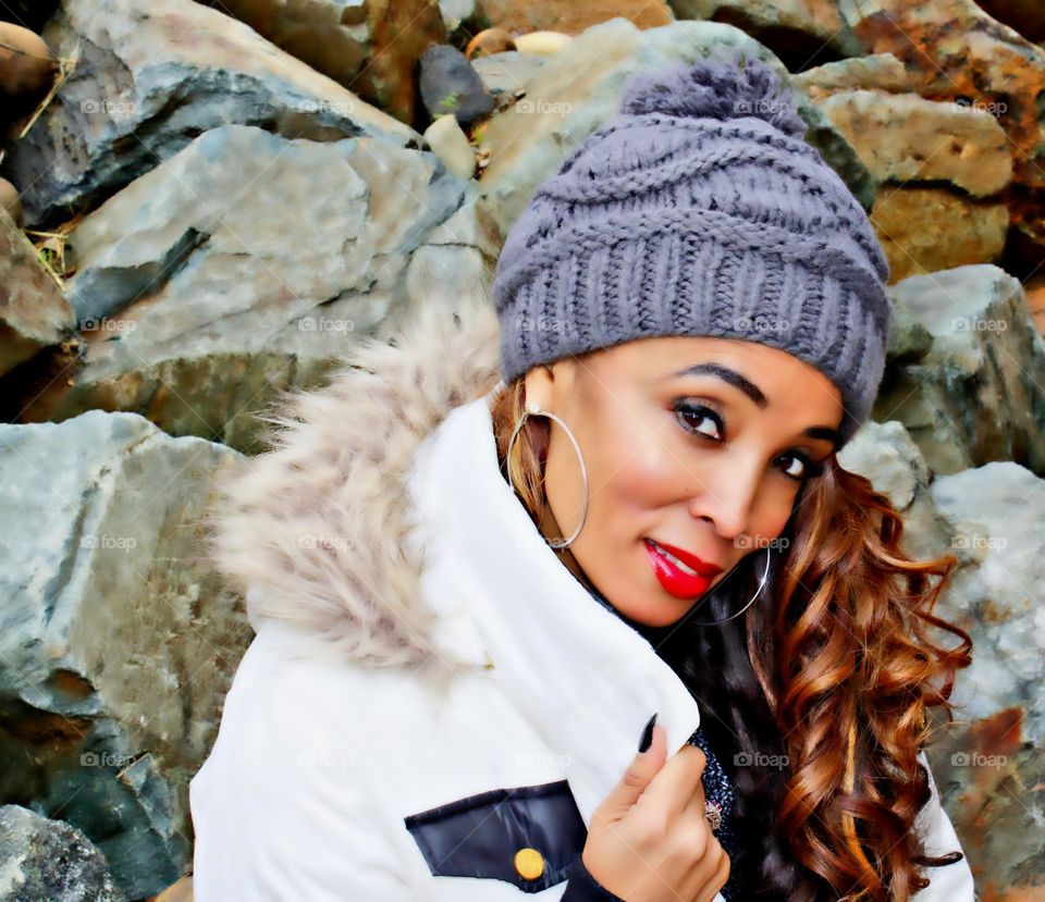 fashion model posing looking at camera with rocks in the background