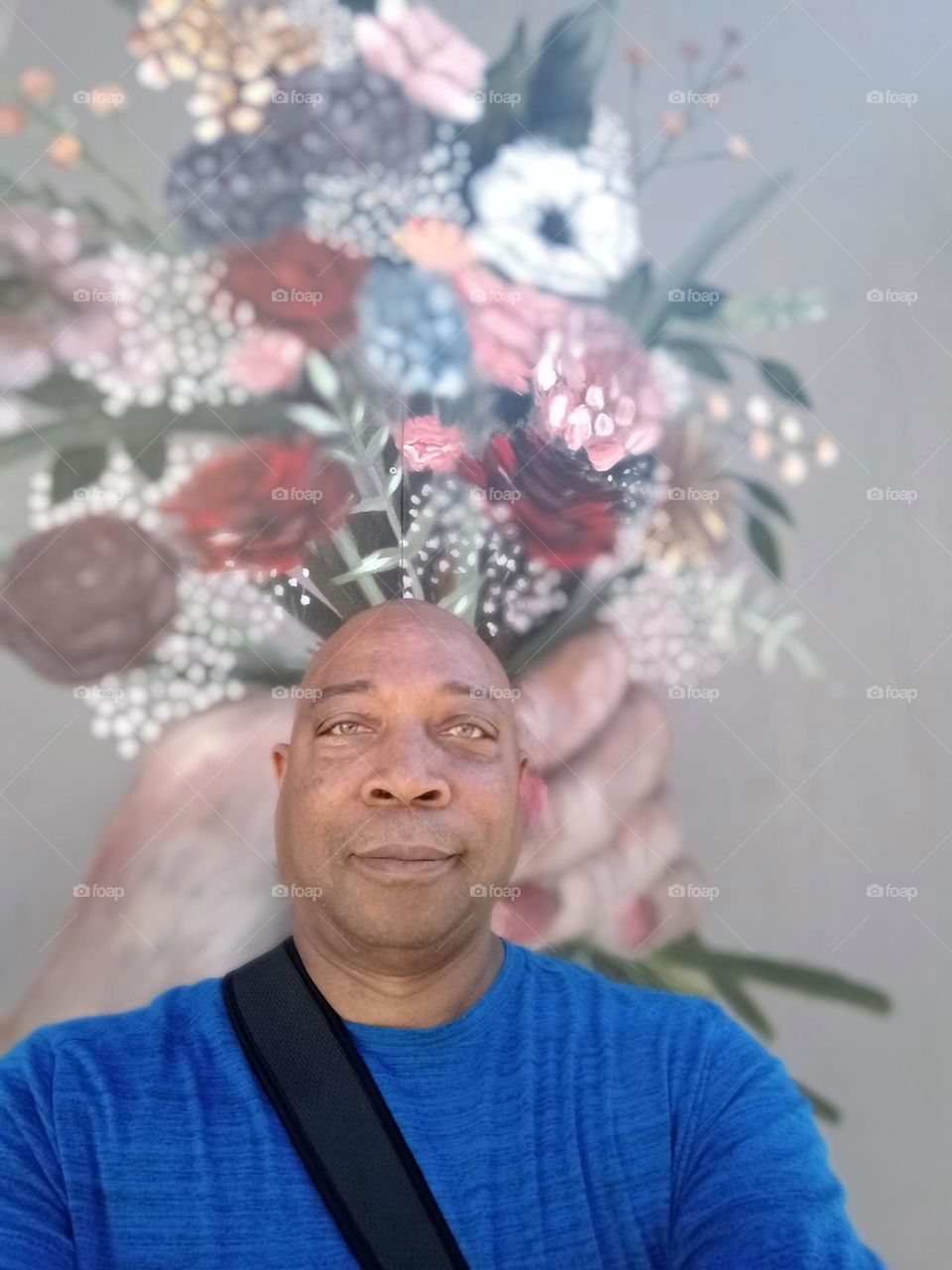 Self-portrait of a man with graffiti wall art in the background