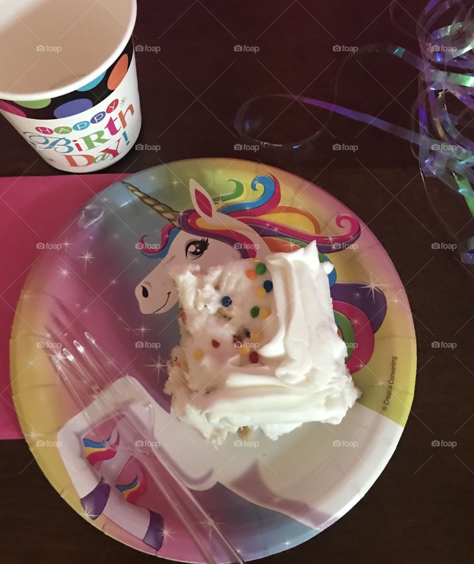 Unicorns and rainbows celebrating a child’s birthday with colorful sprinkles of bright rainbow colors