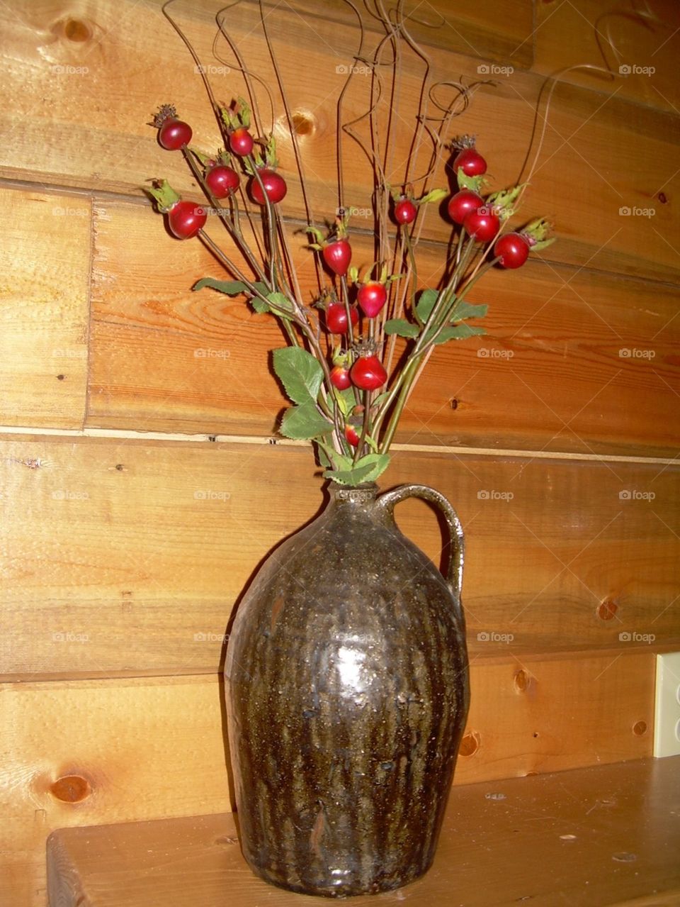 Antique jug with berries