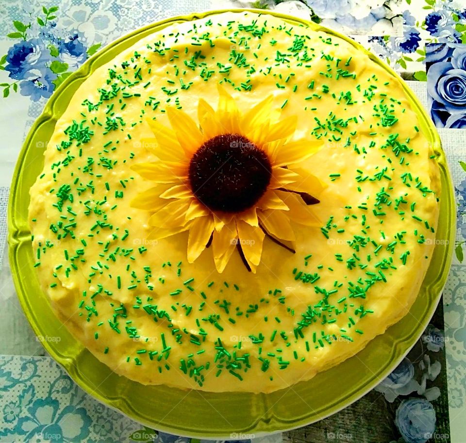 A close-up of a homemade sunflower cake with lemon cream